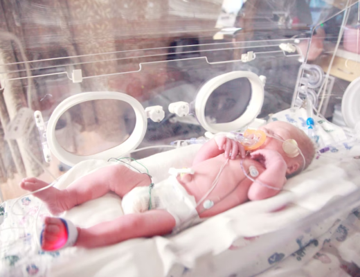Newborn baby on incubator