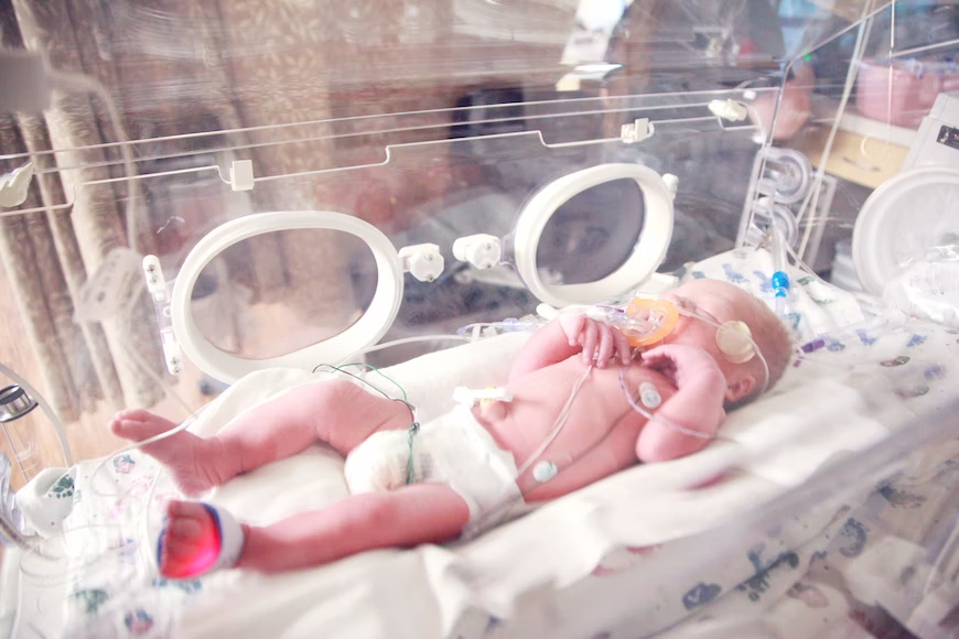 Newborn baby on incubator